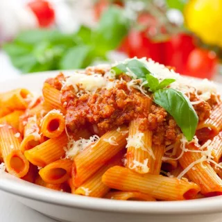 Classic Bolognese Pasta - Penne, Garnished with Basil and Parmesan