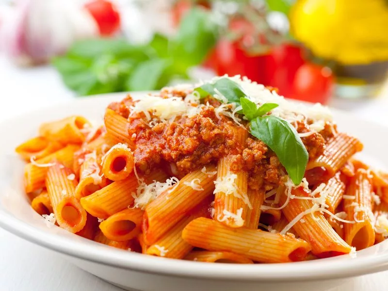 Classic Bolognese Pasta - Penne, Garnished with Basil and Parmesan