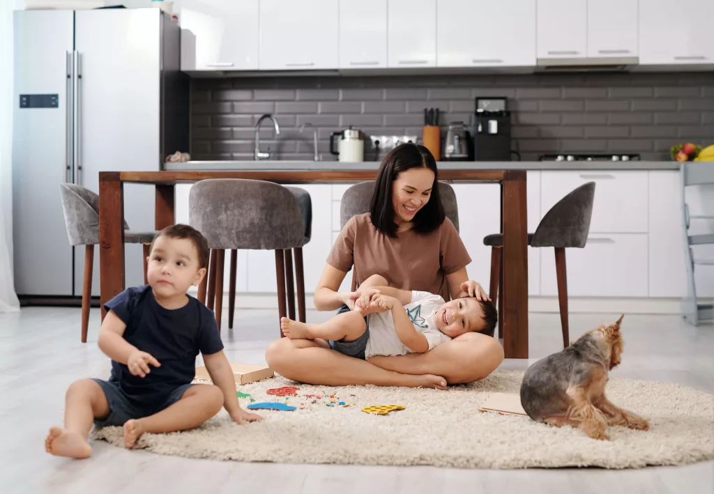 family on rug with dog